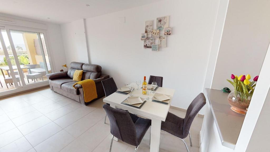 a living room with a table and a couch at Casa Francia - A Murcia Holiday Rentals Property in Roldán