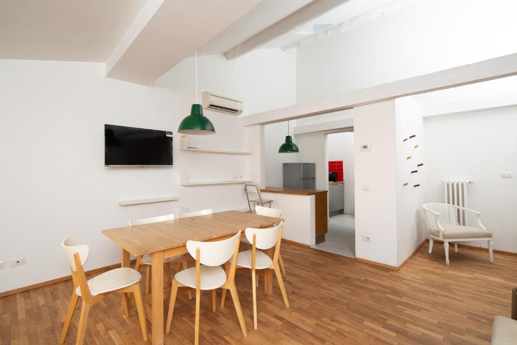 a kitchen and dining room with a wooden table and chairs at Ghiberti House in Florence