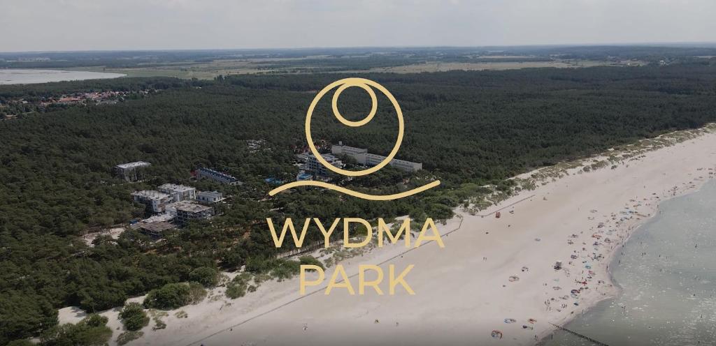 an aerial view of the beach and the sign for wimbledon park at Wydma Park in Rowy