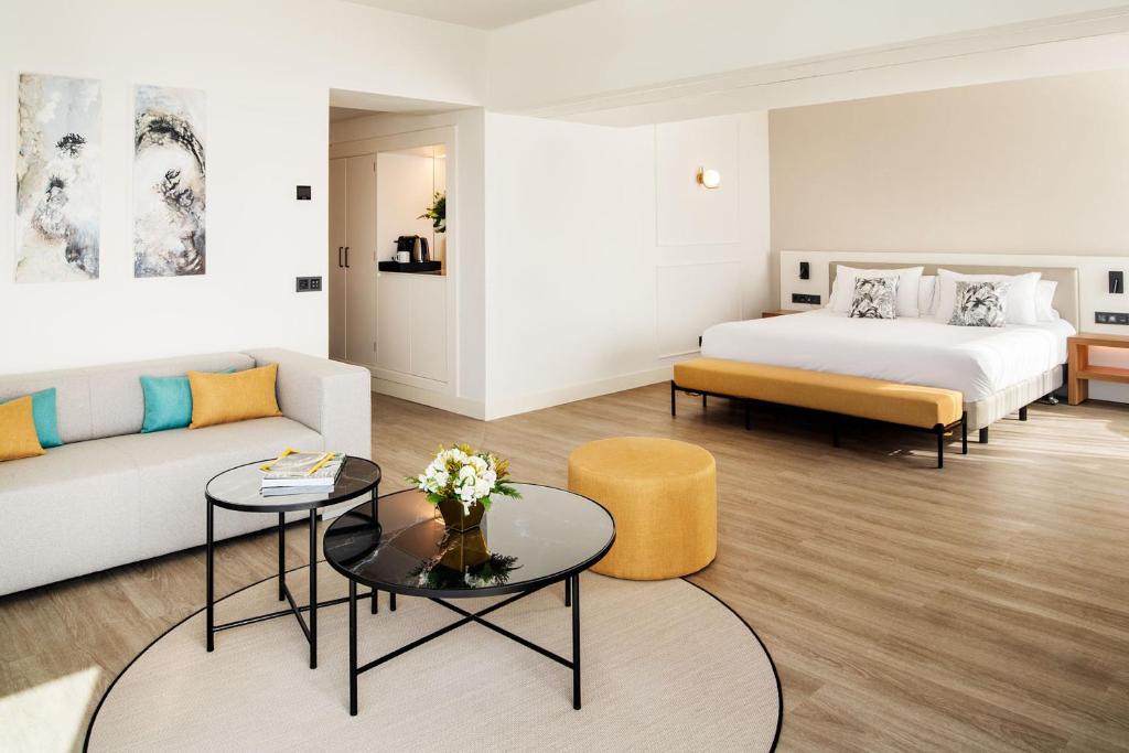 a hotel room with a bed and a couch at Arrecife Gran Hotel & Spa in Arrecife
