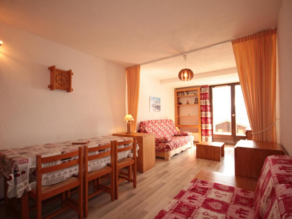 a living room with a table and a couch at Studio Les Saisies, 1 pièce, 4 personnes - FR-1-293-173 in Les Saisies