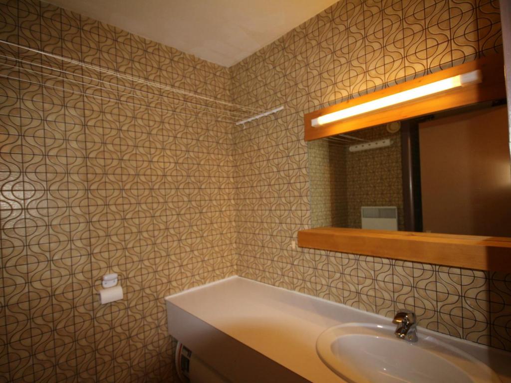a bathroom with a sink and a mirror at Studio Les Saisies, 1 pièce, 4 personnes - FR-1-293-173 in Les Saisies