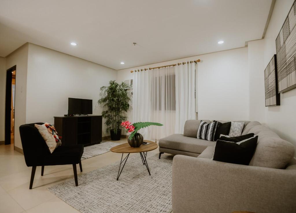 a living room with a couch and a table at Sta Barbara Residence Hotel in Cebu City