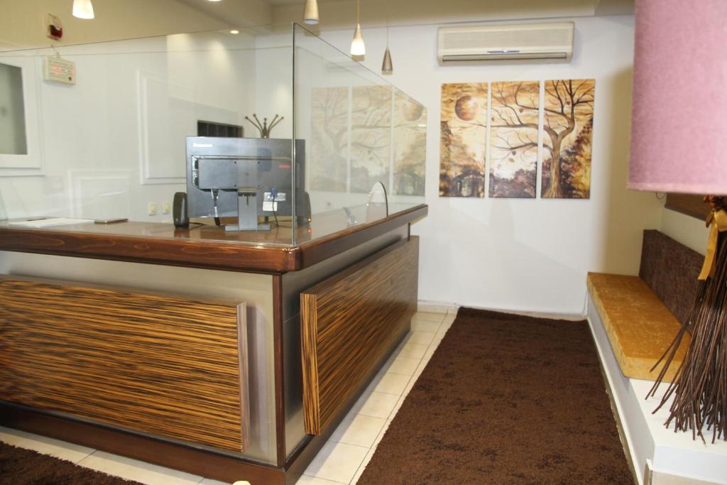 a lobby with a desk with a computer on it at Hotel Selini in Agrinion