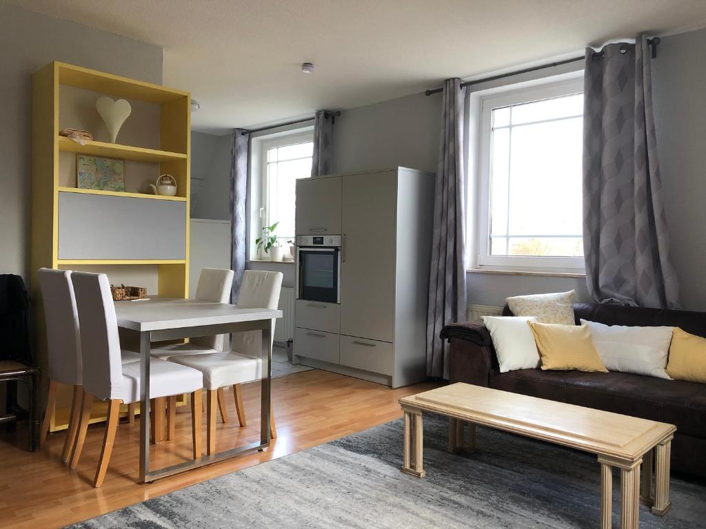 a living room with a table and a couch at Ferienwohnung Seeblick Ratzeburg in Ratzeburg