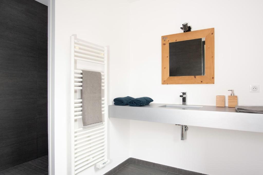 een badkamer met een wastafel en een spiegel bij CHALET ALTAÏ in Séez