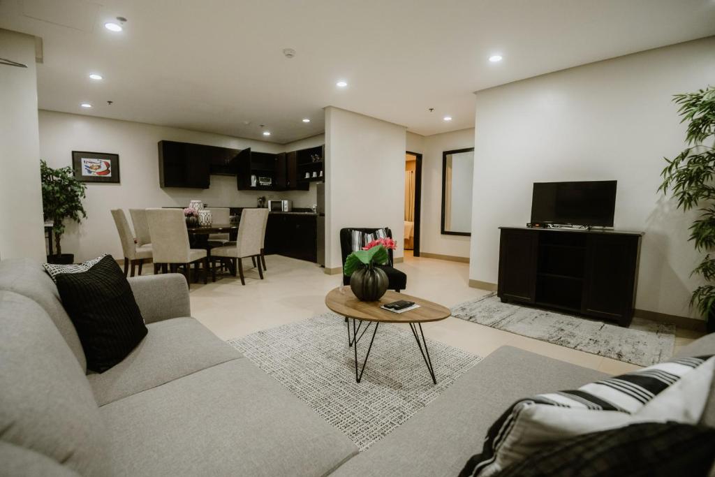 a living room with a couch and a table at Sta Barbara Residence Hotel in Cebu City