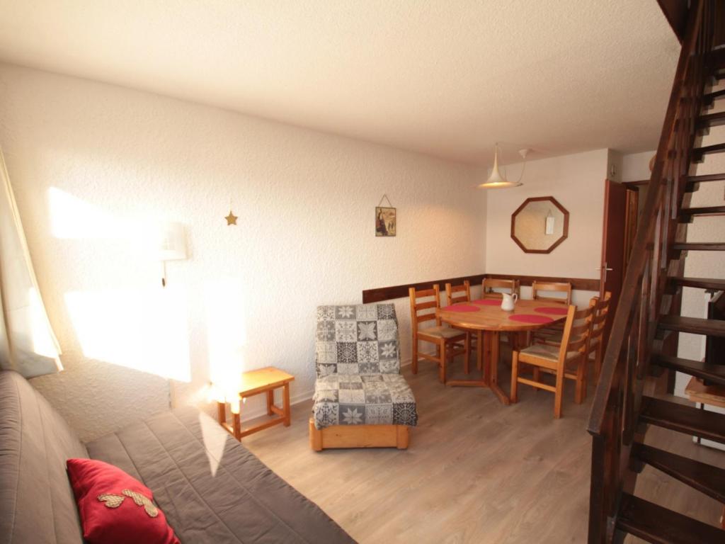 a living room and dining room with a table and chair at Appartement Les Saisies, 2 pièces, 7 personnes - FR-1-293-221 in Les Saisies