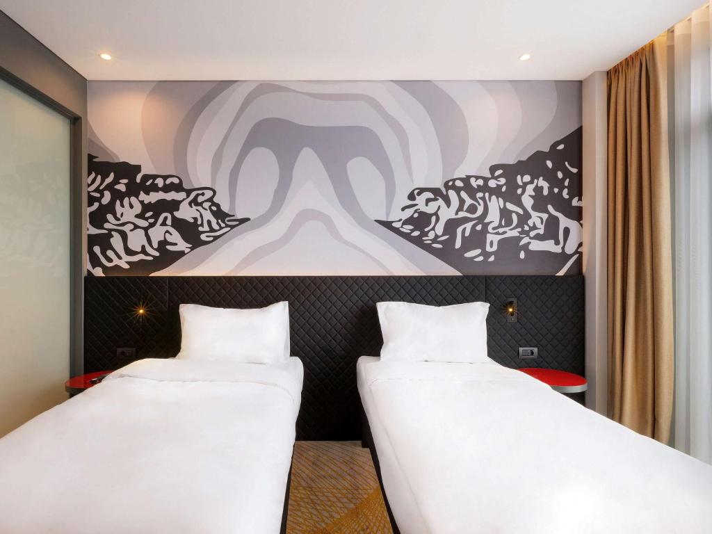 A bed or beds in a room at ibis Styles Istanbul Merter