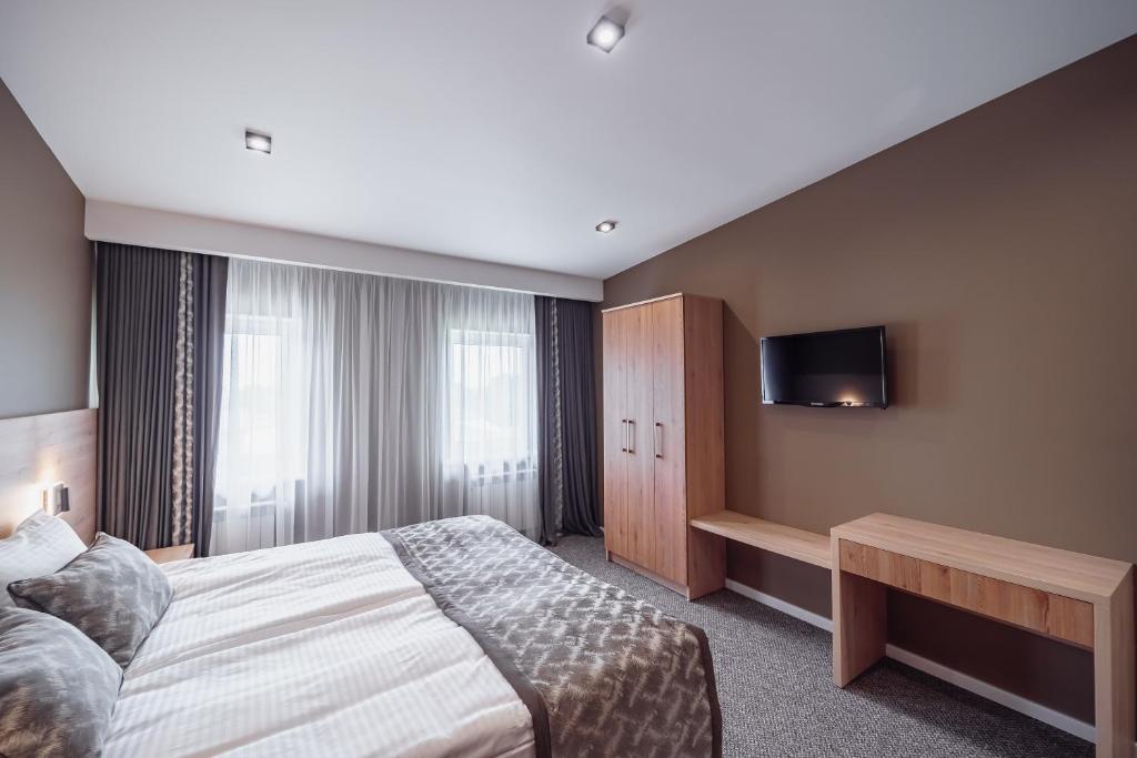 Postel nebo postele na pokoji v ubytování Rudison Hotel & Restaurant
