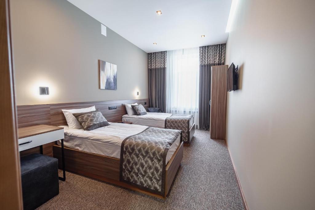 Postel nebo postele na pokoji v ubytování Rudison Hotel & Restaurant