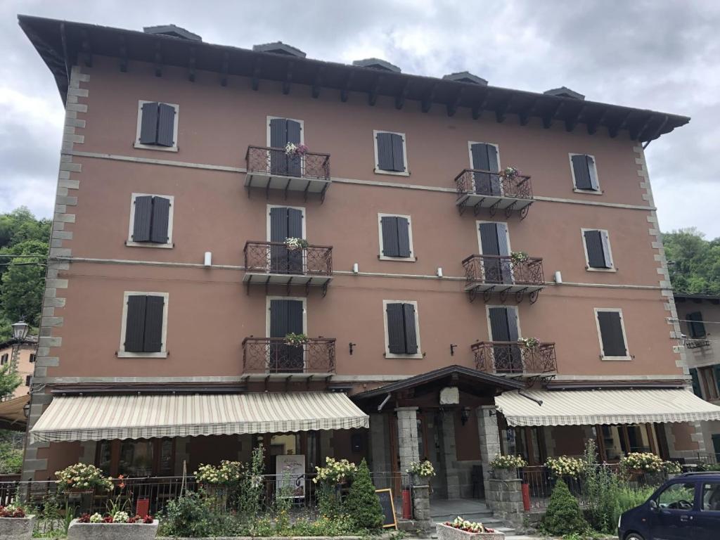 a large pink building with balconies and windows at Hotel Appennino in Fiumalbo