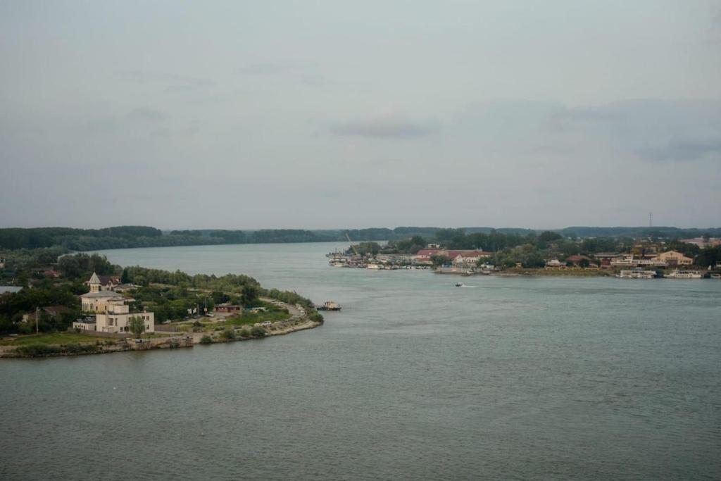 a view of a river with houses and a town at DELTA DANUBE VIEW apart in Tulcea