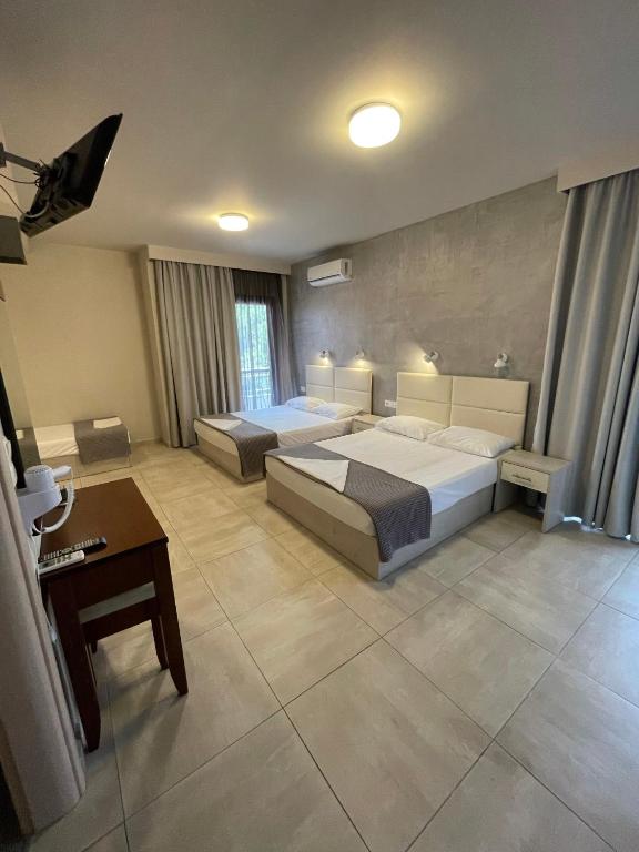 Postel nebo postele na pokoji v ubytování Afrodite Beach