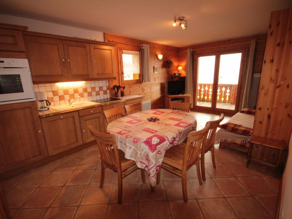 a kitchen with a table and some chairs and a kitchen with a table at Appartement Villard-sur-Doron, 3 pièces, 6 personnes - FR-1-293-254 in Villard-sur-Doron