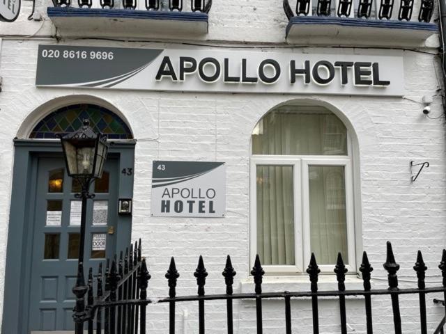 a apollo hotel building with a fence in front of it at Apollo Hotel Kings Cross in London