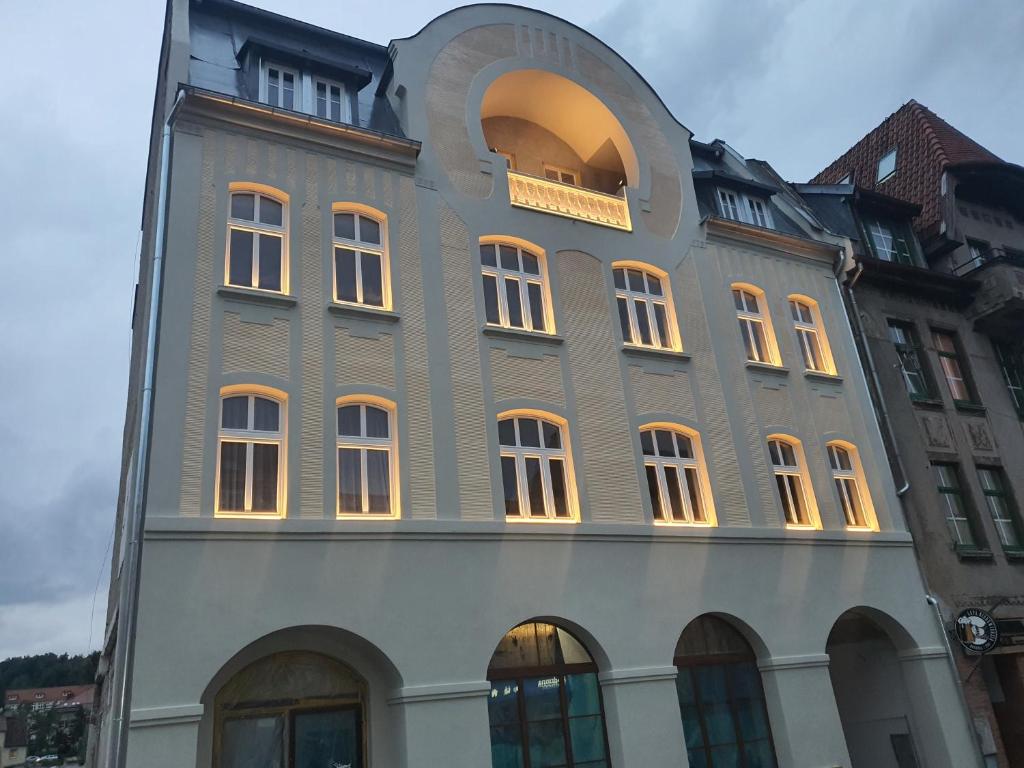 a building with an archway on the side of it at Apartamenty Polonia Mrągowo in Mrągowo