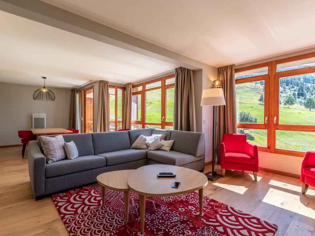a living room with a couch and a table at Appartement Les Arcs 1800, 4 pièces, 6 personnes - FR-1-352-57 in Arc 1800