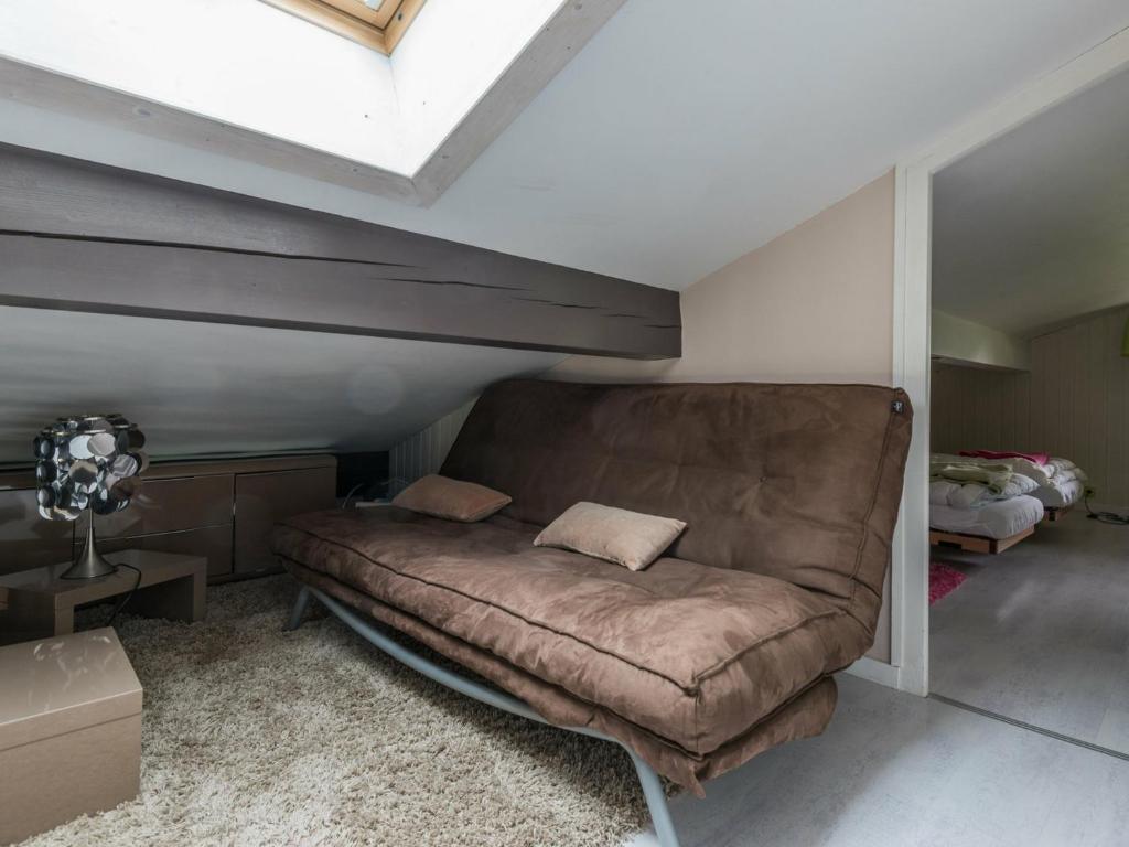 a living room with a couch in a attic at Appartement Chamonix-Mont-Blanc, 4 pièces, 6 personnes - FR-1-517-11 in Chamonix