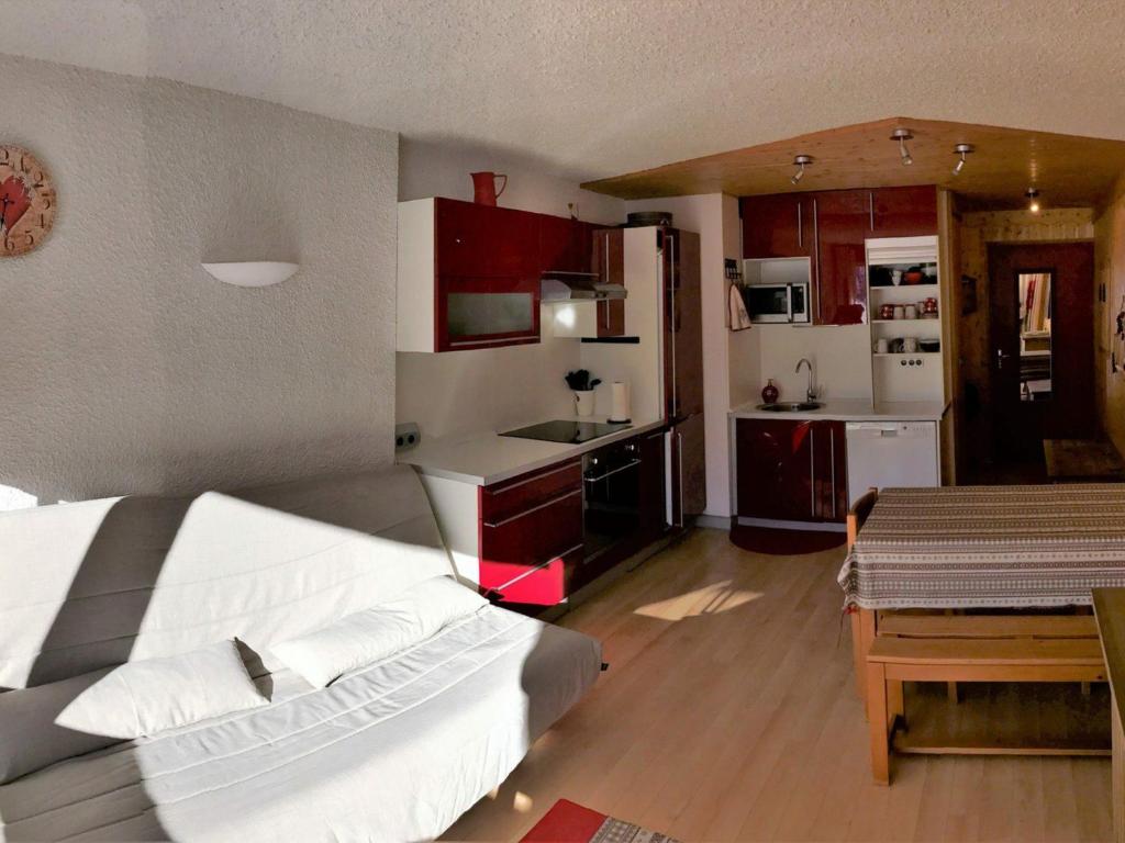 1 dormitorio con 1 cama blanca y cocina en Appartement Corrençon-en-Vercors, 2 pièces, 6 personnes - FR-1-515-17, en Corrençon-en-Vercors