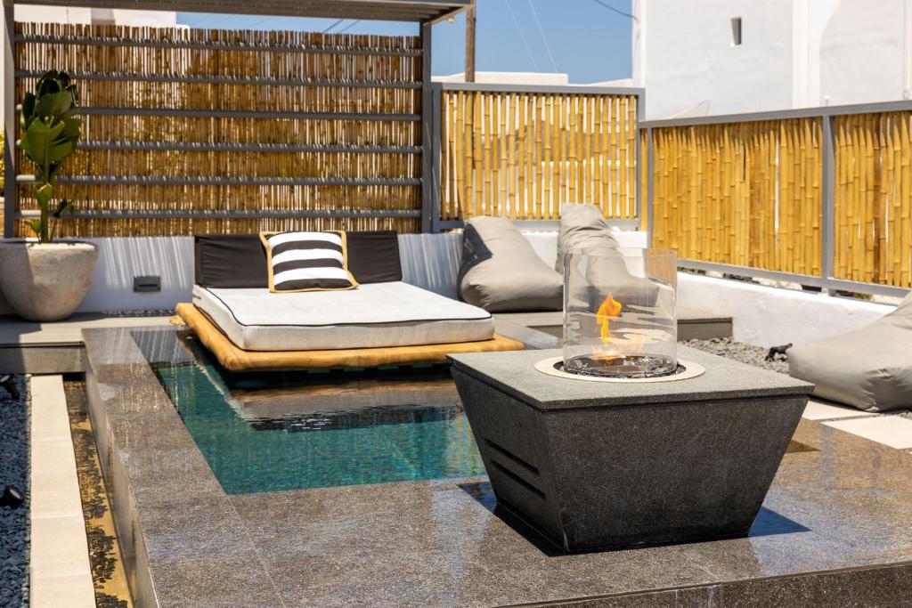 a patio with a couch and a fire pit at Parion Opus in Naousa