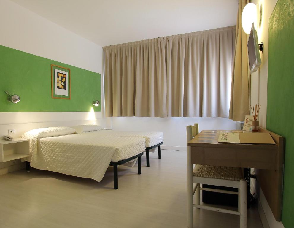 En eller flere senger på et rom på Hotel Giardino