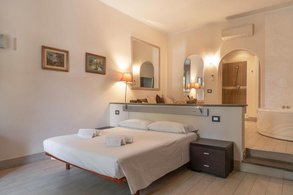 a bedroom with a large bed and a bath room at TIBERINA APARTMENTS - ROME TRASTEVERE in Rome
