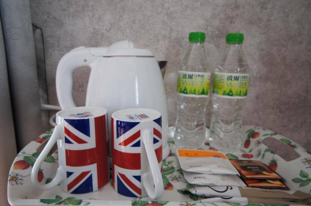 a tea kettle and two bottles of water on a table at Brulee's Done in Dongshan