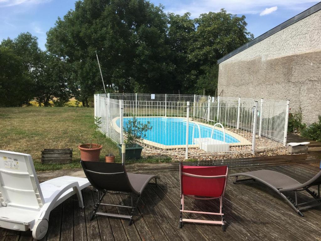 a group of chairs sitting next to a swimming pool at Gîte Athienville, 6 pièces, 12 personnes - FR-1-584-84 in Athienville