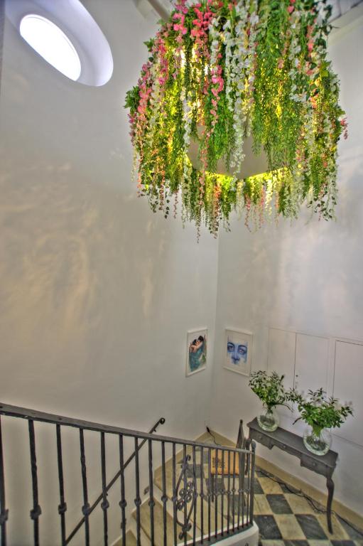 a chandelier with flowers hanging from a ceiling at La Casa de la Favorita in Tarifa