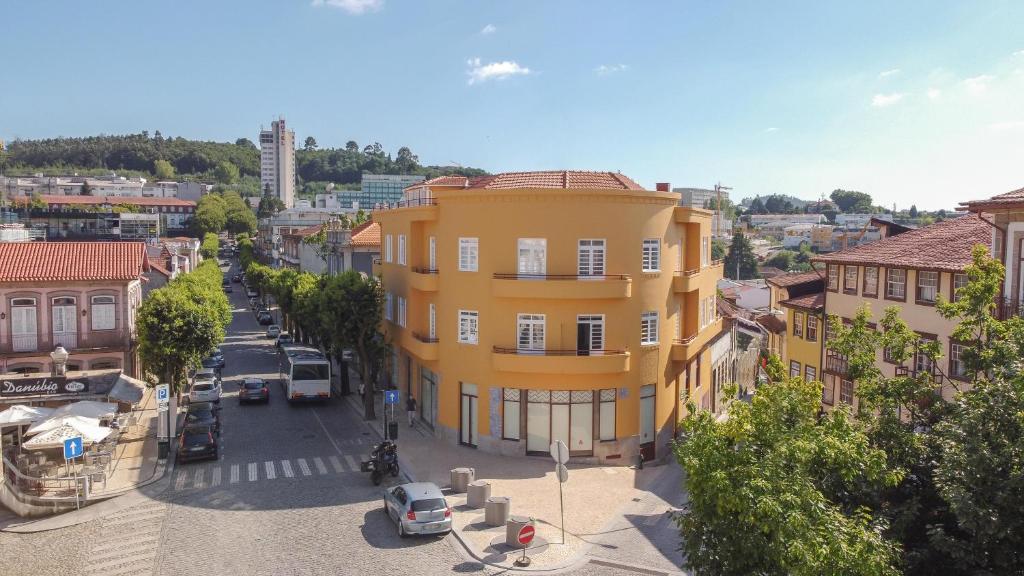 a yellow building on the side of a street at FERREIRA'S HOUSE Guimarães in Guimarães