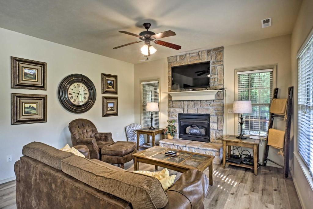 a living room with a couch and a fireplace at Branson West Villa w/ Golf Course View & Pool! in Branson West