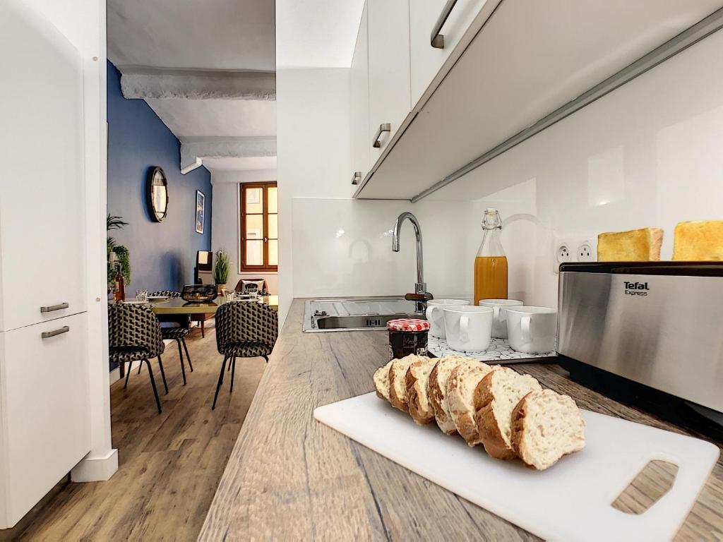 a kitchen with two loaves of bread on a counter at Nestor&amp;Jeeves - DESIGN VIEUX NICE - Old Town - Close sea in Nice