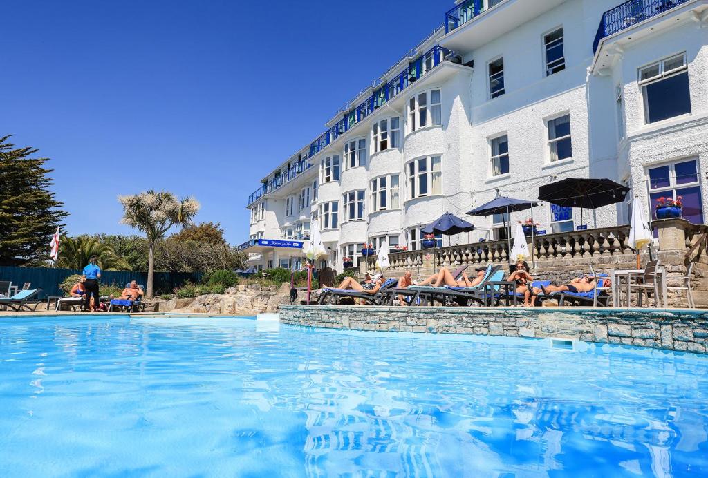 a large swimming pool in front of a hotel at Marsham Court Hotel in Bournemouth