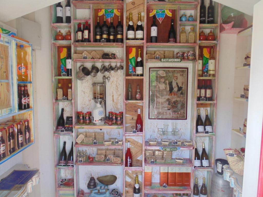 a wall filled with lots of bottles of wine at Villa Ana Margarida Beach in Ericeira
