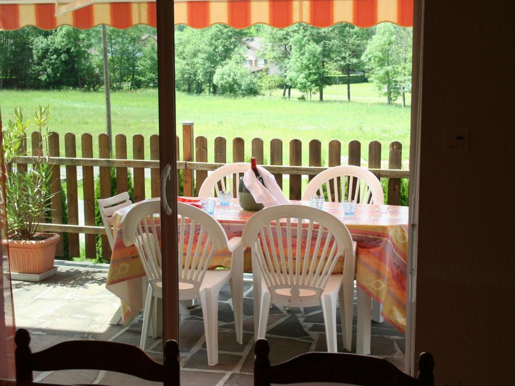 a table and chairs on a porch with a view of a field at Gîte Saulcy-sur-Meurthe, 5 pièces, 8 personnes - FR-1-589-200 in Saulcy-sur-Meurthe