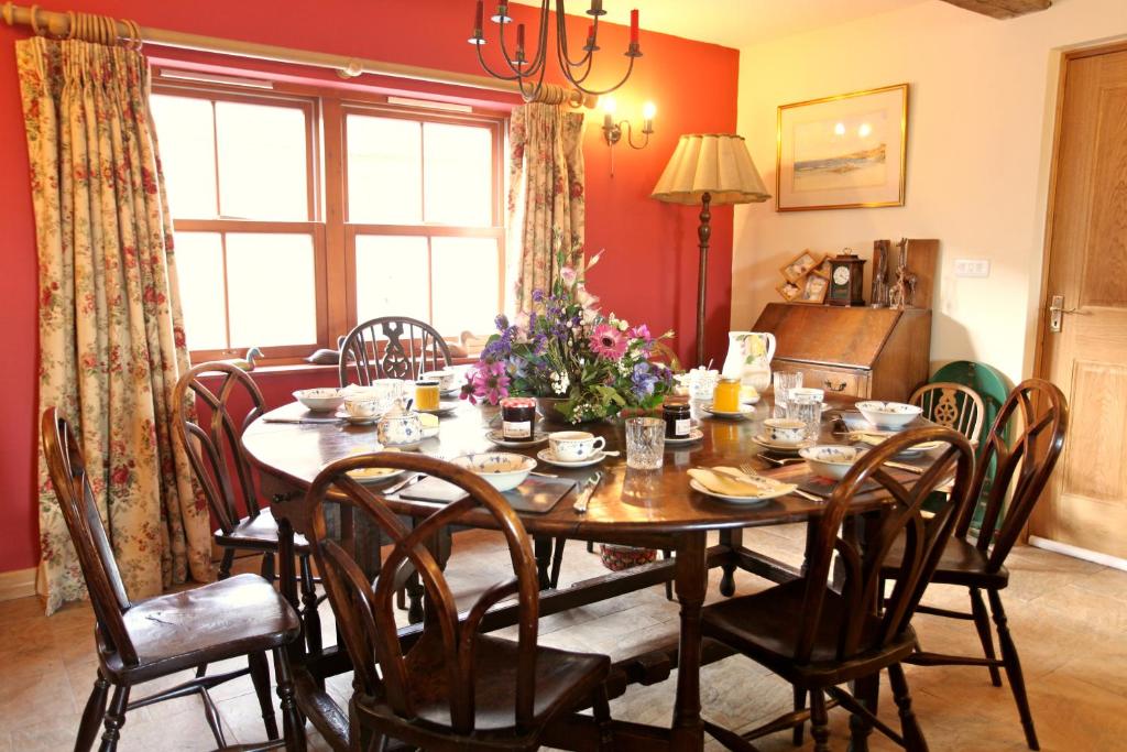 a dining room with a table and chairs at Knockaloe Beg Farm in Patrick