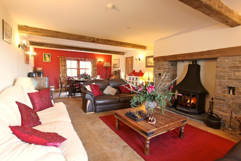 a living room with a white couch and a fireplace at Knockaloe Beg Farm in Patrick