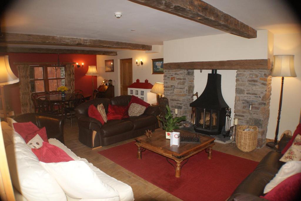 a living room with a couch and a fireplace at Knockaloe Beg Farm in Patrick
