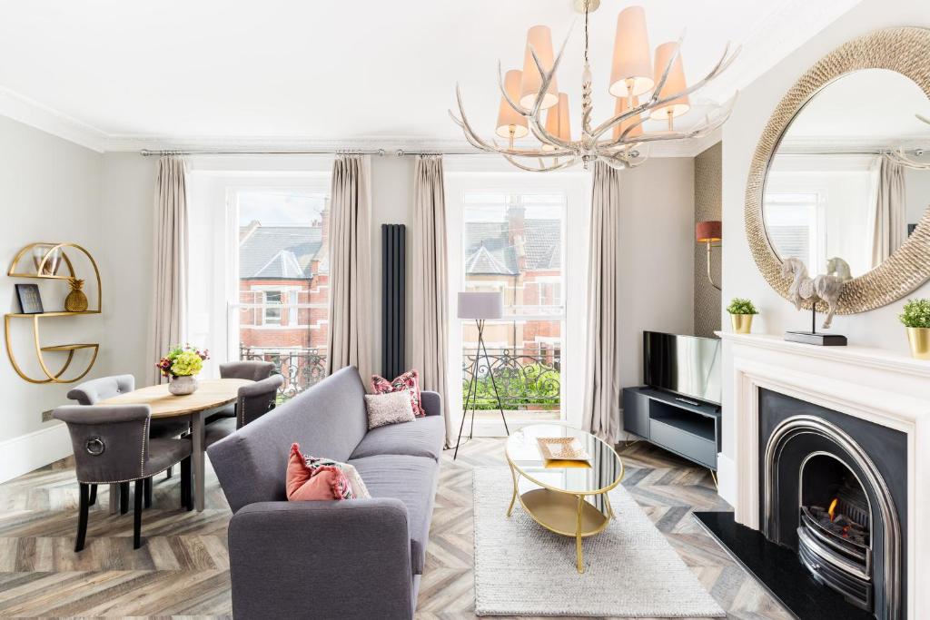 a living room with a couch and a fireplace at L-Spa Boutique Apartments in Leamington Spa