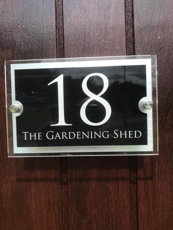 a sign on a door that reads the gardening shed at The Garden Shed 1 in Builth Wells