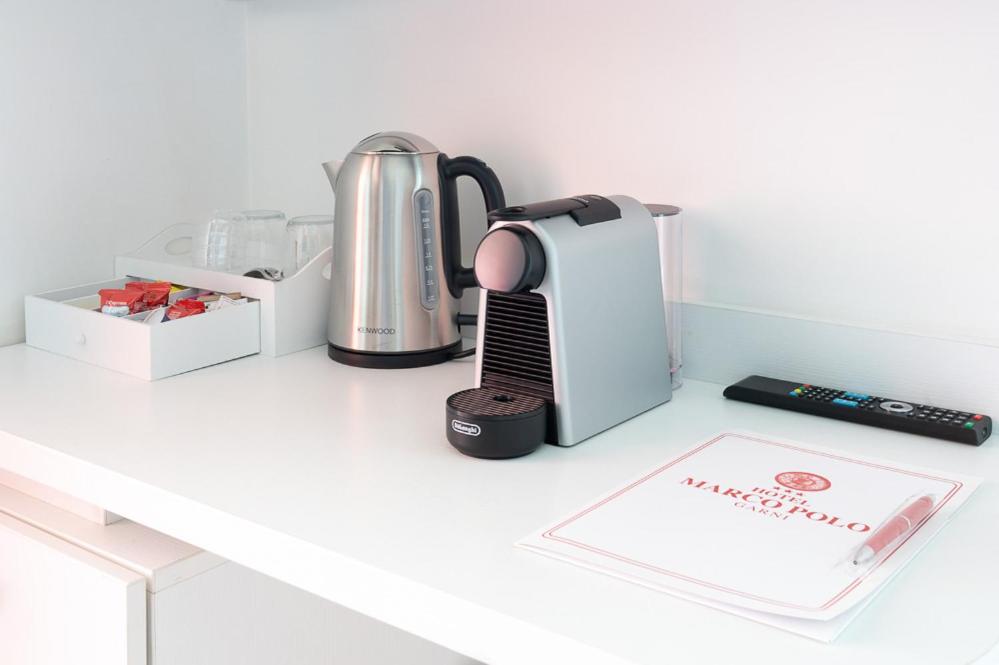 a kitchen counter with a blender and a book at Hotel Marco Polo in Lido di Jesolo