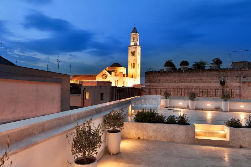 vistas a un edificio con una torre de reloj por la noche en Palazzo Calò, en Bari