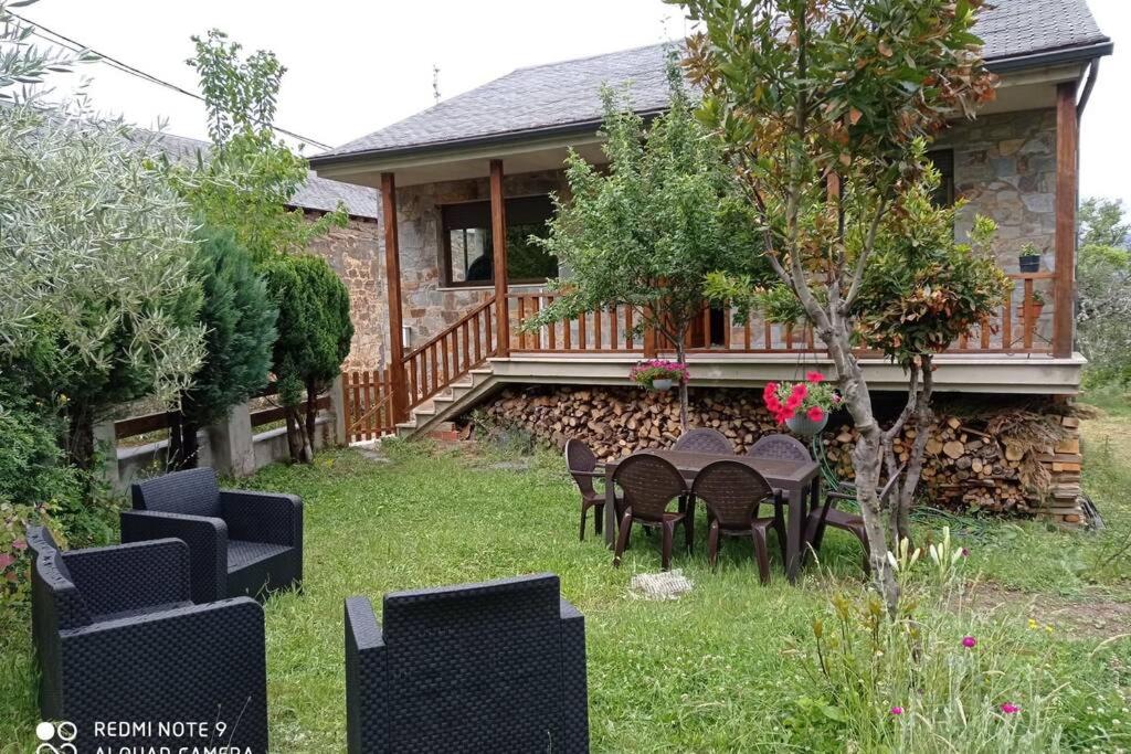 un patio con sillas y una mesa frente a una casa en Entrecastaños, en Rozas