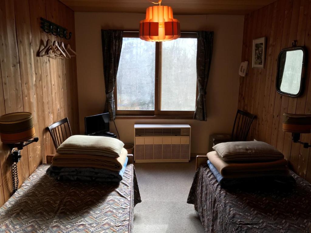 a room with two beds and a window at New Togakushi Sea Hail - Vacation STAY 51752v in Nagano