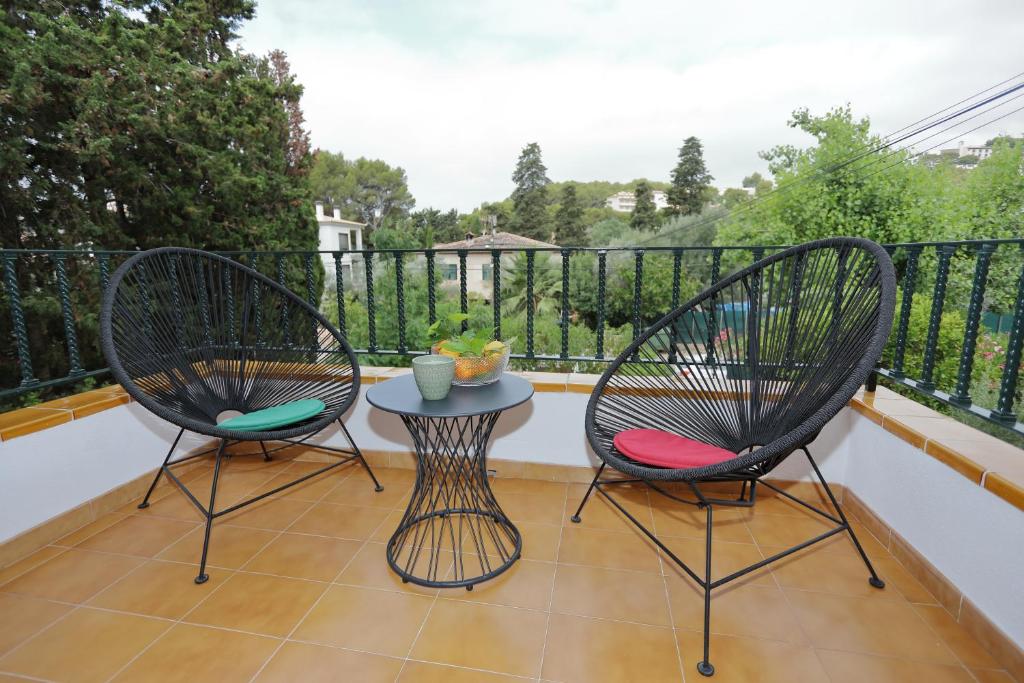 two chairs and a table on a balcony at Patricia's, lovely apartment in Port de Sóller in Port de Soller