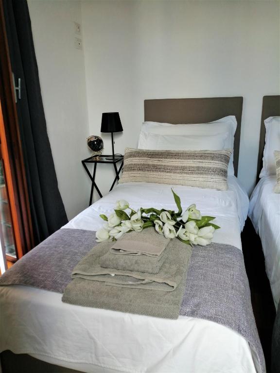 A bed or beds in a room at EMI's Guest House