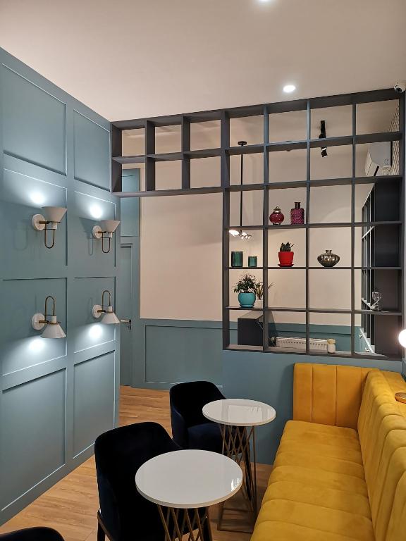 a living room with a couch and two tables at 3 Rooms Hotel in Tbilisi City