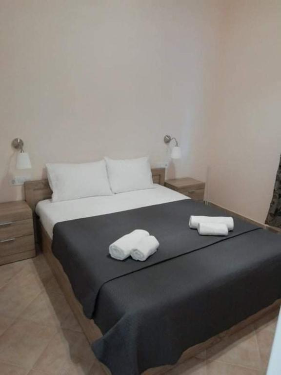 a bedroom with a bed with two towels on it at Aquastelle est 2021 in Neos Marmaras