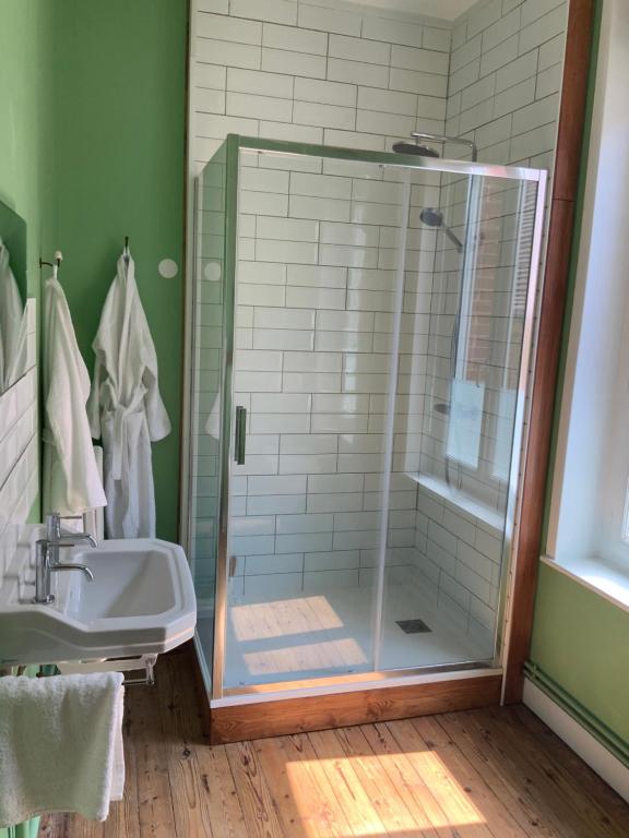 a bathroom with a shower and a sink at Par la Dives in Saint-Pierre-sur-Dives